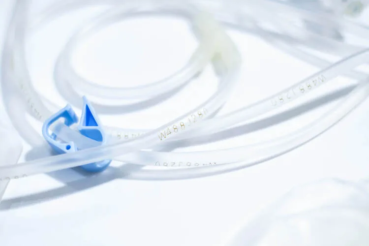 Custom injection molded plastic connectors and IV components integrated into a medical tubing system